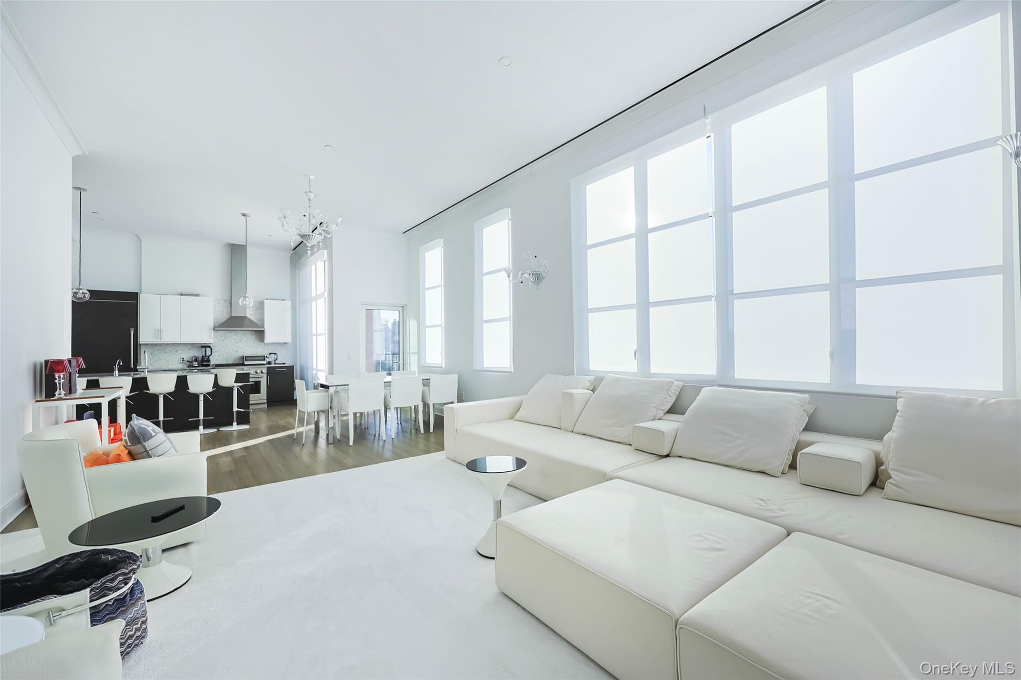 100 Garvies Point Road, Unit 1024 Glen Cove, NY 11542 - Photo 26 of 41 a living room with furniture and a large window