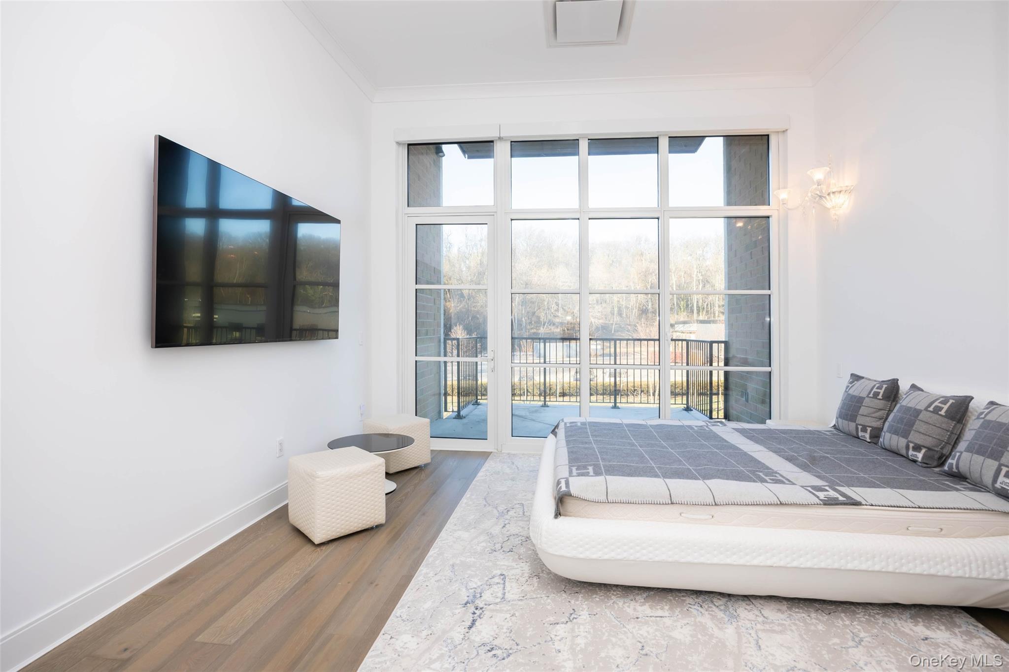 100 Garvies Point Road, Unit 1024 Glen Cove, NY 11542 - Photo 32 of 41 a living room with furniture and a flat screen tv