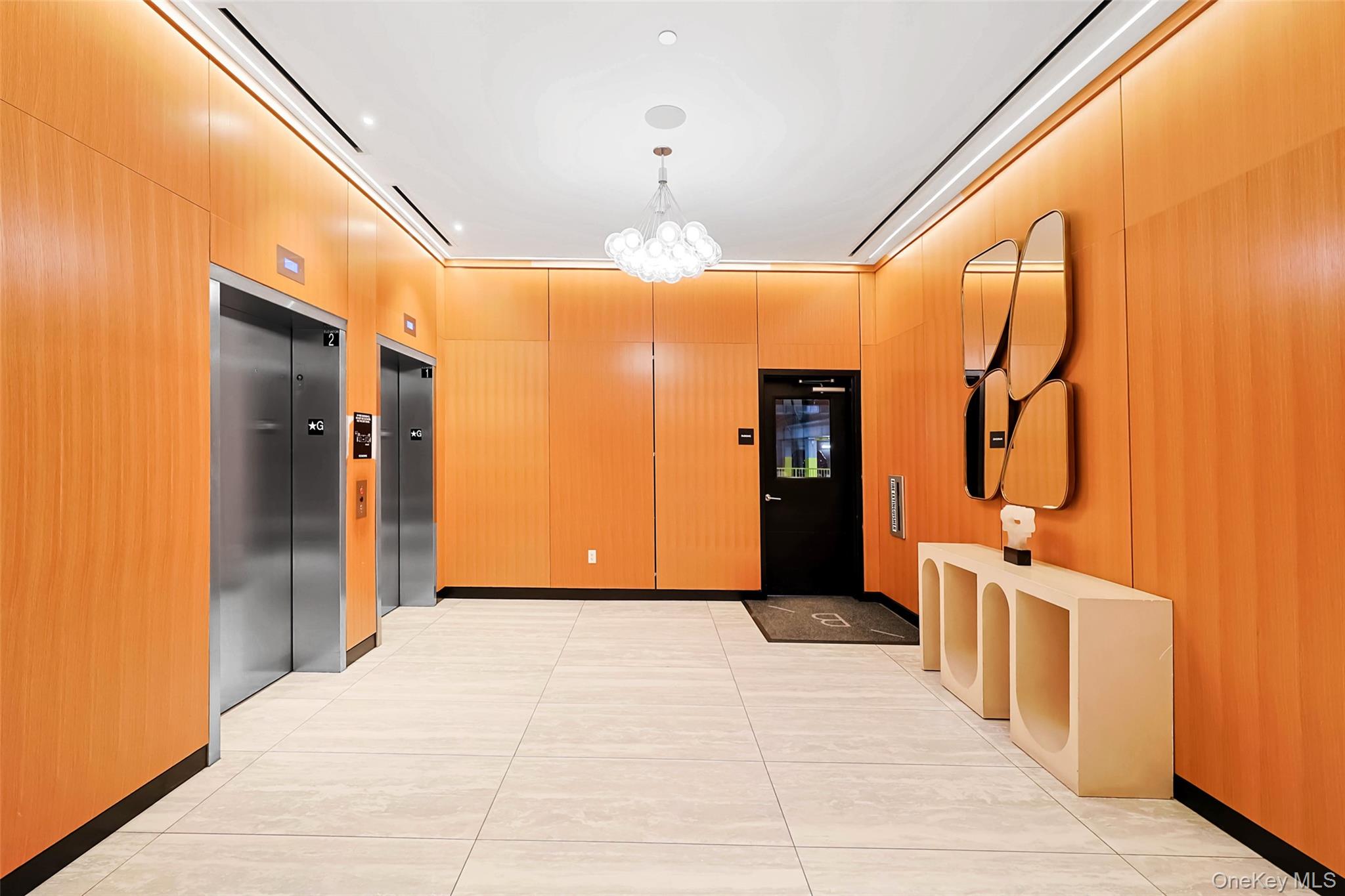 100 Garvies Point Road, Unit 1024 Glen Cove, NY 11542 - Photo 5 of 41 a view of a hallway with wooden shelves