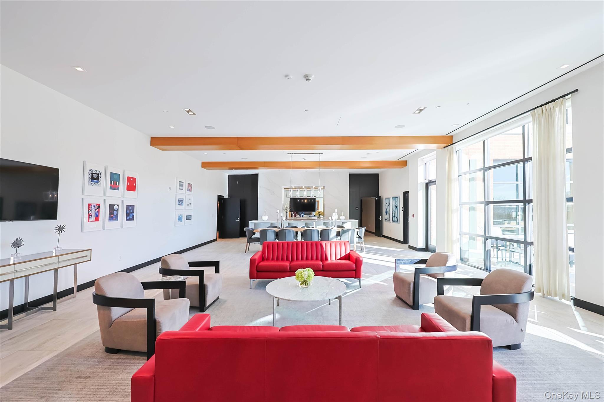 100 Garvies Point Road, Unit 1024 Glen Cove, NY 11542 - Photo 9 of 41 a bedroom with furniture and a large window