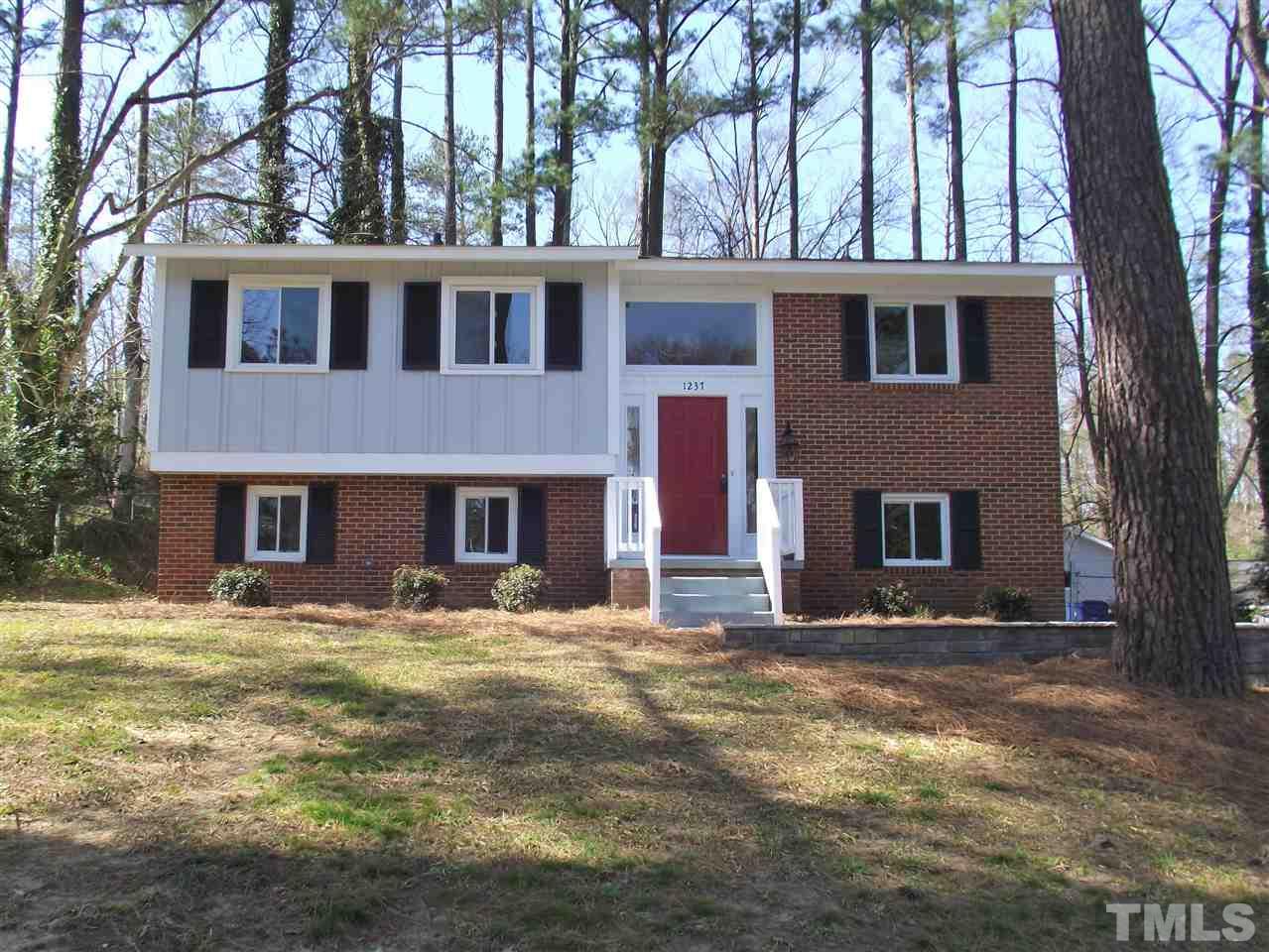 1237 Somerset Road Raleigh, NC 27610 - Photo 1 of 25 a front view of a building with a yard