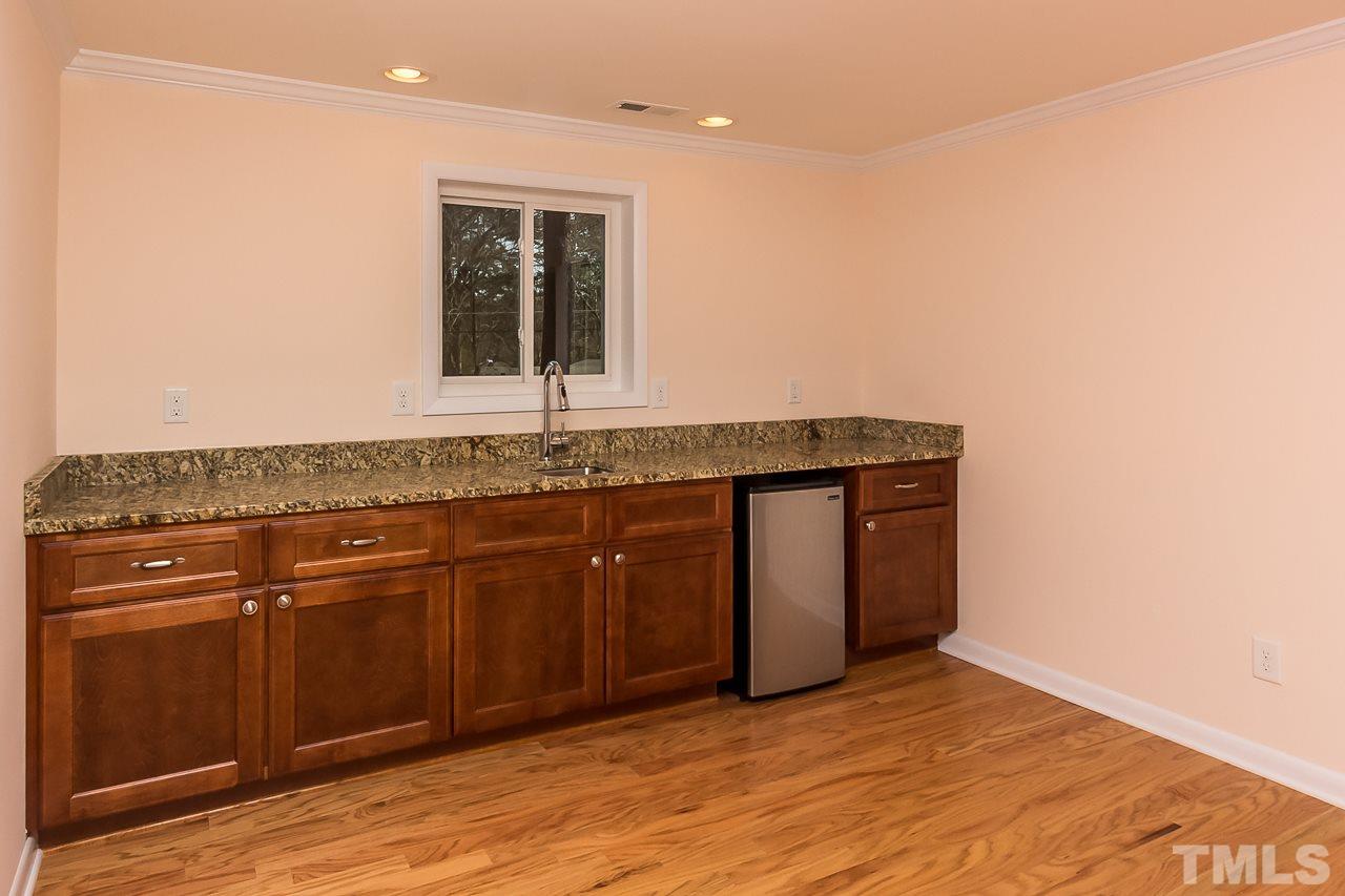 1237 Somerset Road Raleigh, NC 27610 - Photo 13 of 25 a kitchen with a sink cabinets and wooden floor