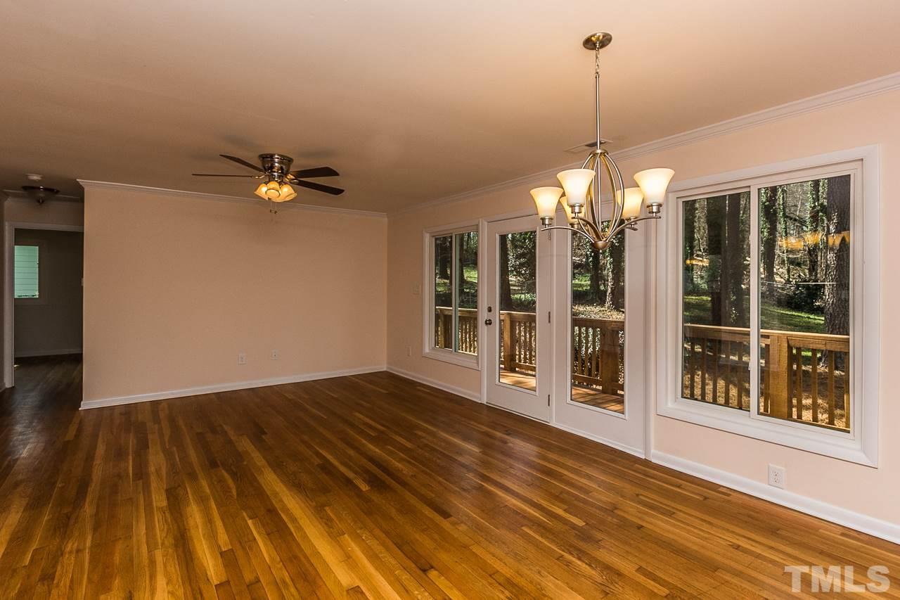 1237 Somerset Road Raleigh, NC 27610 - Photo 18 of 25 a view of a room with wooden floor chandelier and windows