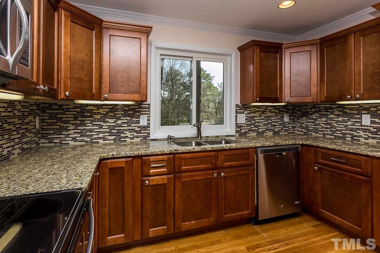 1237 Somerset Road Raleigh, NC 27610 - Photo 10 of 25 a kitchen with sink a window and cabinets