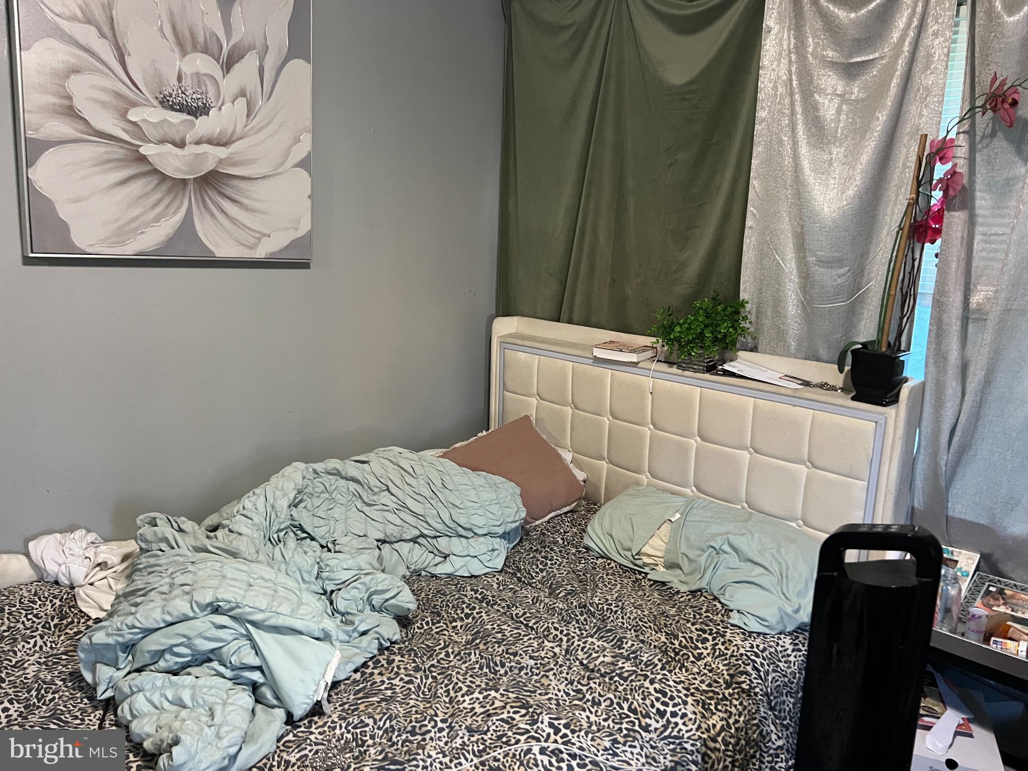 4132 Audrey Avenue Baltimore, MD 21225 - Photo 6 of 14 a bedroom with a bed and wooden floor