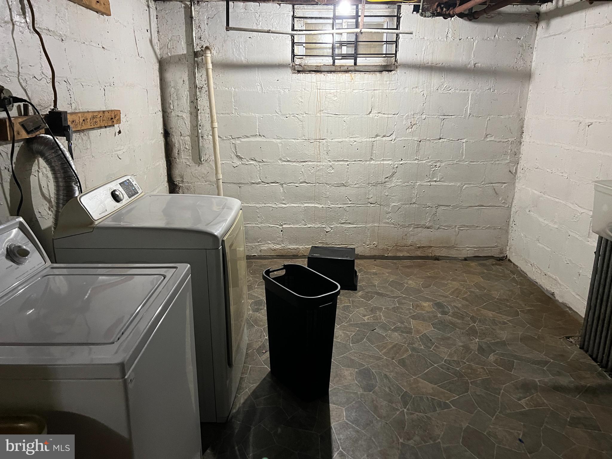 4132 Audrey Avenue Baltimore, MD 21225 - Photo 9 of 14 a bathroom with a granite countertop sink a washer and dryer