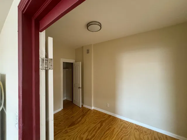 a view of an empty room and wooden floor