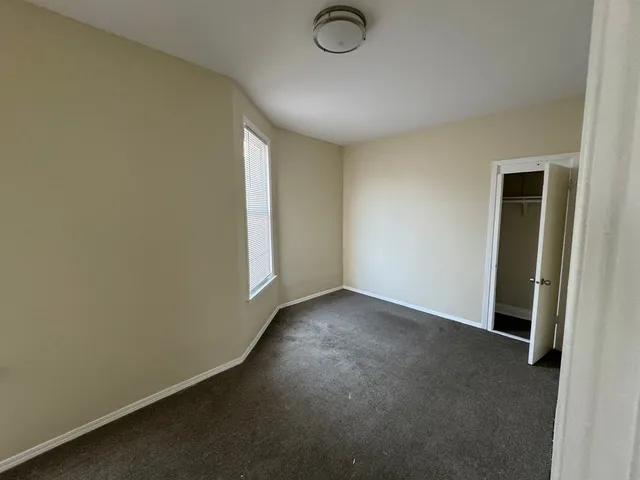 an empty room with a empty space and a window