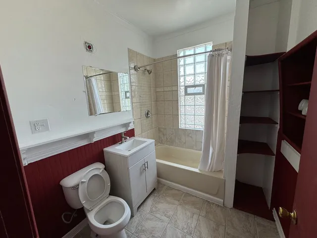 a bathroom with a toilet a sink and bathtub