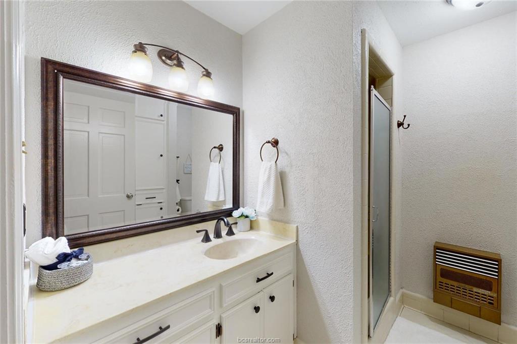 900 Westview Street Bryan, TX 77802 - Photo 21 of 30 a bathroom with a double vanity sink and a mirror