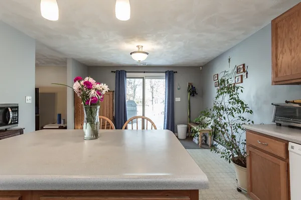 a dining room with furniture and flowers