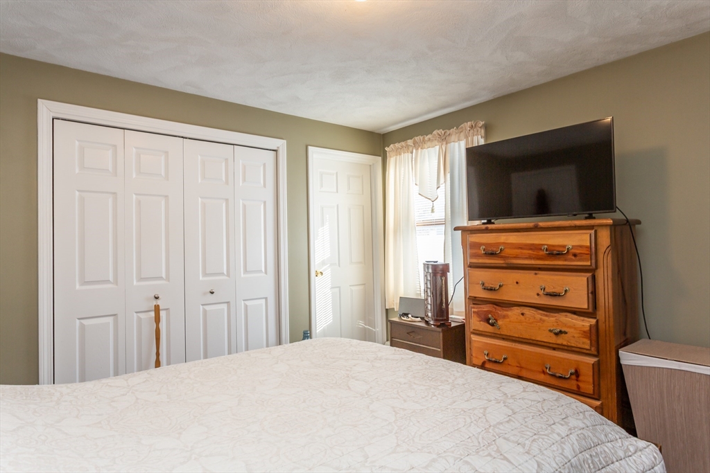 95 Hiatt Street Fall River, MA 02721 - Photo 16 of 22 a room with a bed and a television in it