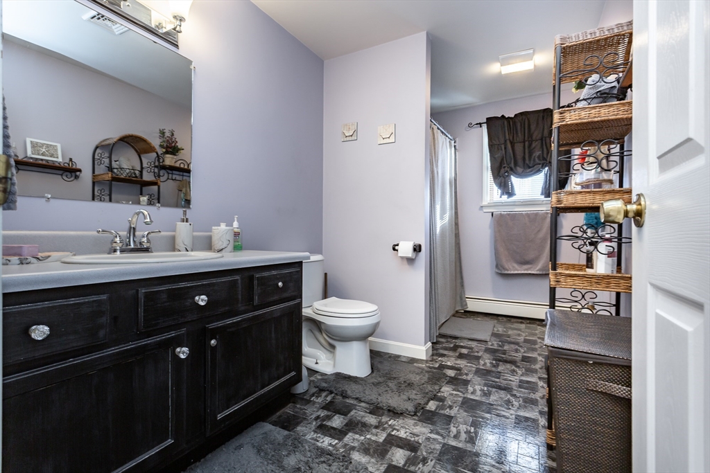 95 Hiatt Street Fall River, MA 02721 - Photo 17 of 22 a bathroom with a toilet sink double vanity and mirror