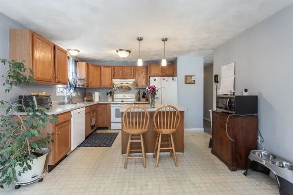 a kitchen with a sink a counter top space appliances and a window