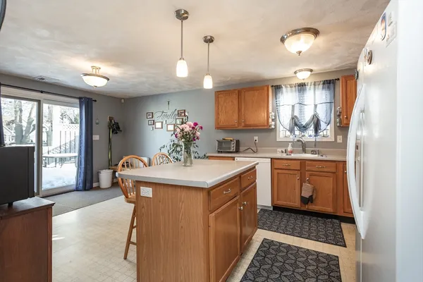 a kitchen with a sink stove and refrigerator
