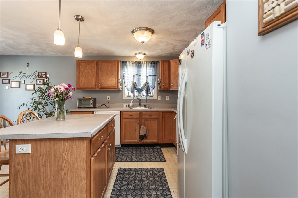 95 Hiatt Street Fall River, MA 02721 - Photo 10 of 22 a kitchen with a sink stove and cabinets