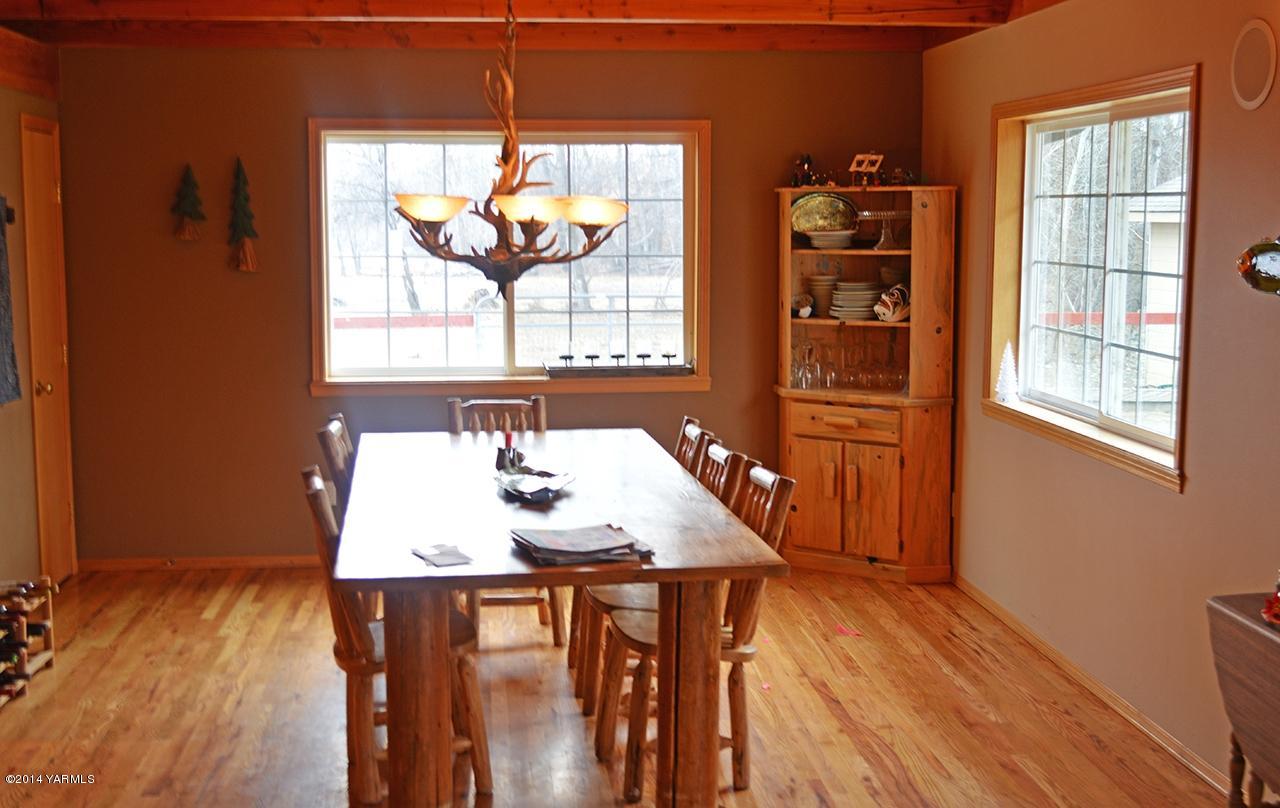 870 Lewis Road Naches, WA 98937 - Photo 11 of 24 a view of a dining room with furniture window and wooden floor