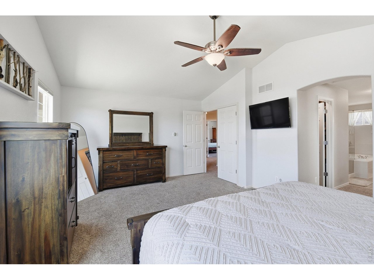 6291 Taylor Street Frederick, CO 80530 - Photo 18 of 50 a bedroom with a bed and a flat screen tv