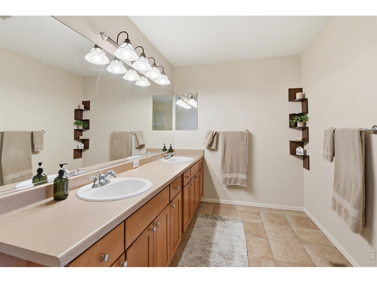 6291 Taylor Street Frederick, CO 80530 - Photo 19 of 50 a bathroom with a sink a mirror and a shower