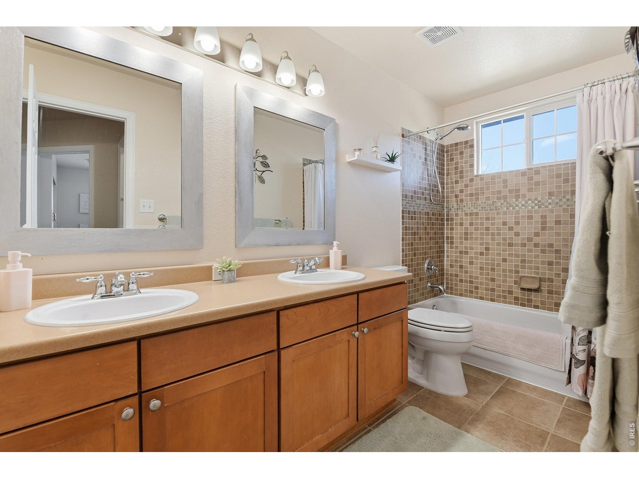 6291 Taylor Street Frederick, CO 80530 - Photo 27 of 50 a bathroom with a sink toilet a mirror and shower