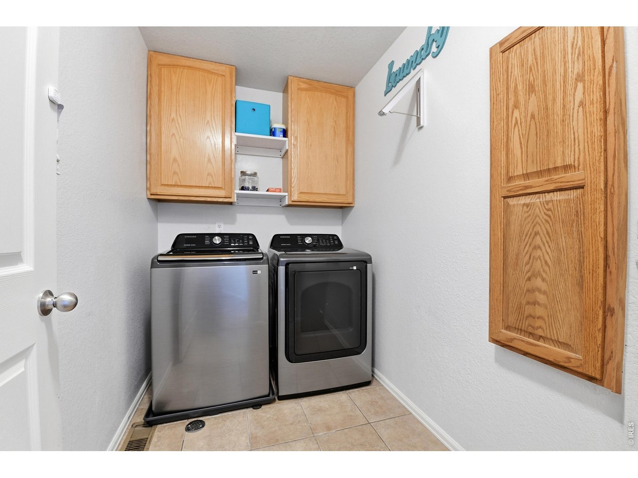6291 Taylor Street Frederick, CO 80530 - Photo 29 of 50 a utility room with wooden floor washer and dryer