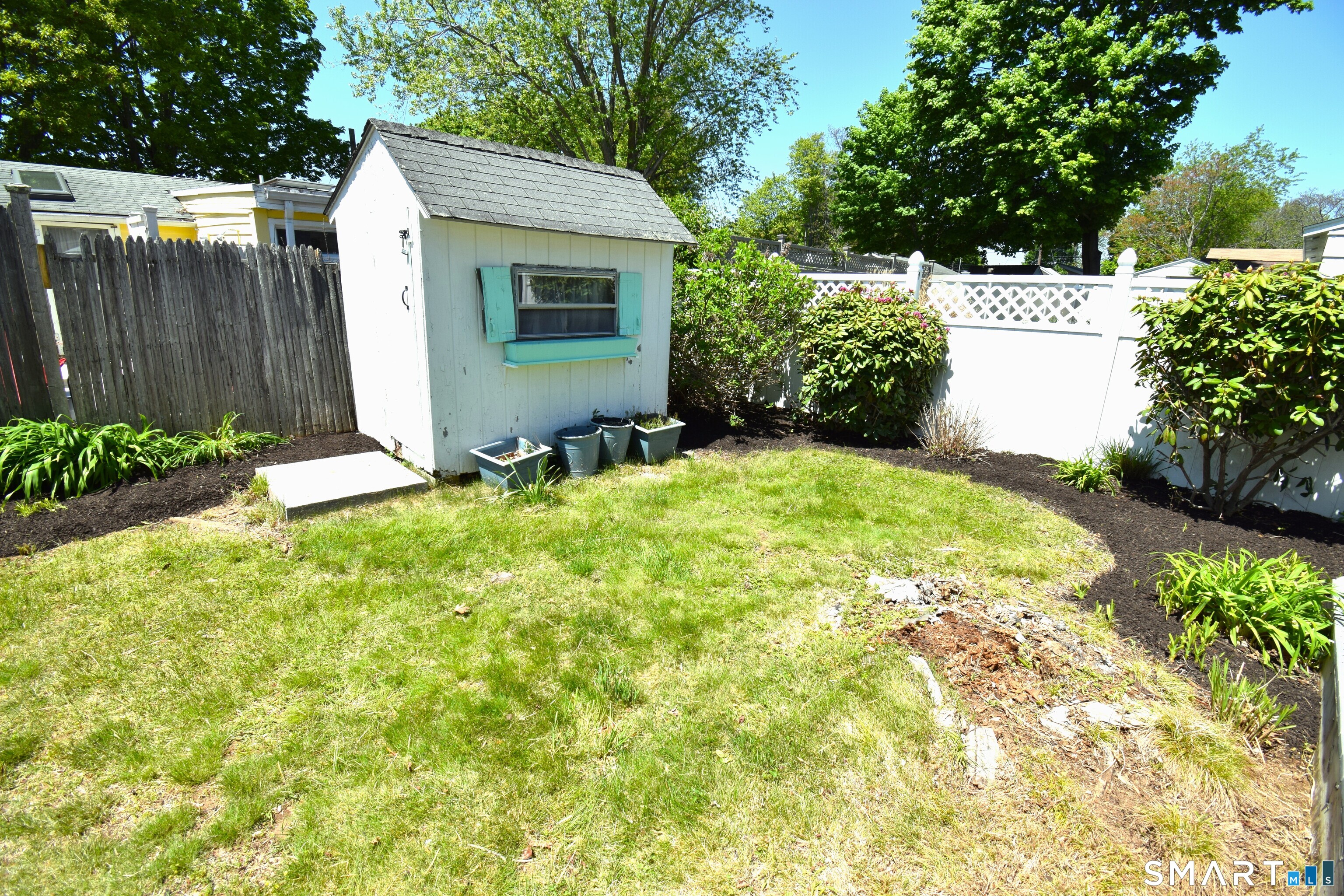 50 East Street Madison, CT 06443 - Photo 22 of 26 a view of a back yard with green space