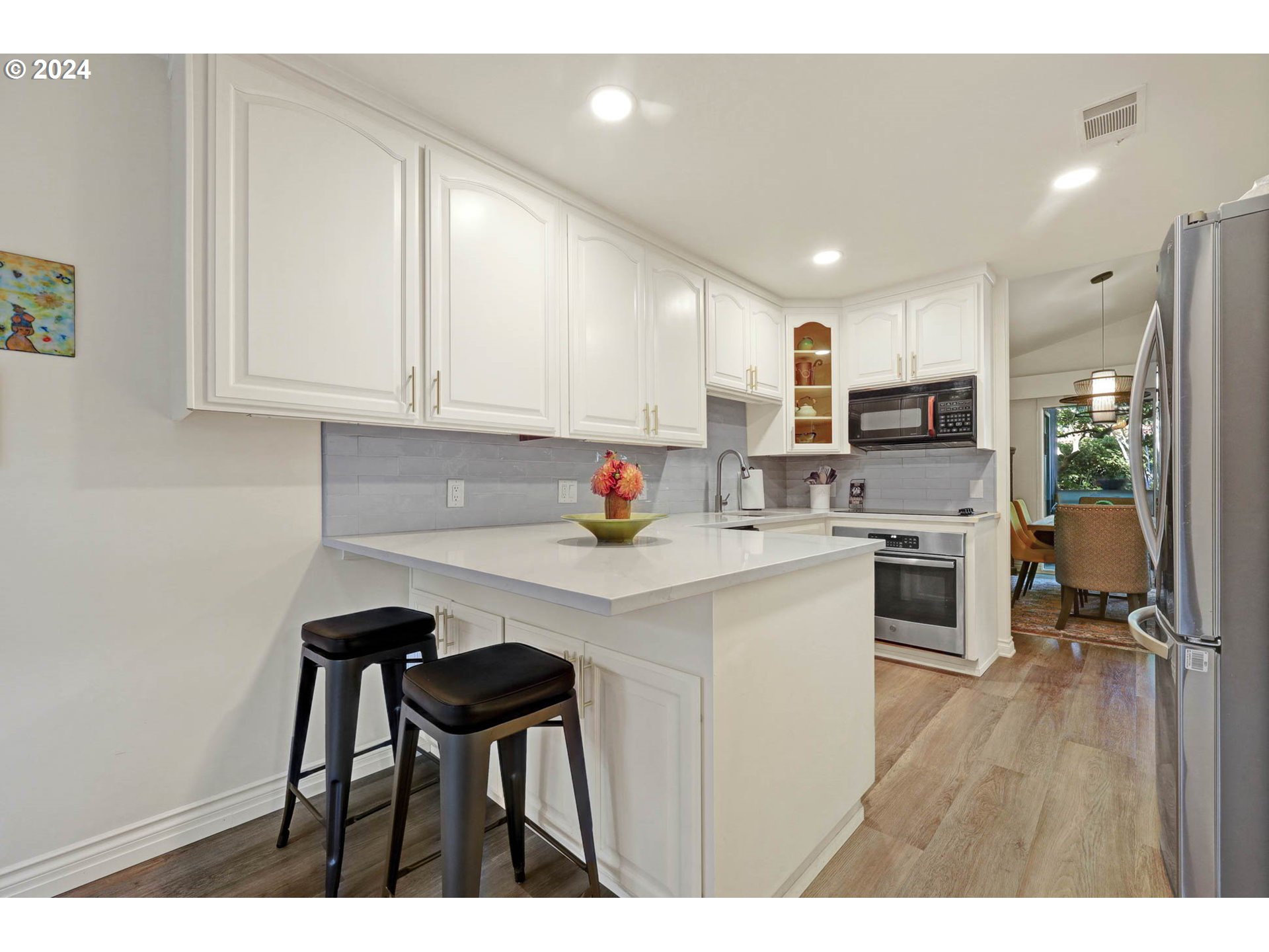1625 Braeman Village Eugene, OR 97405 - Photo 15 of 41 a kitchen with kitchen island granite countertop a sink cabinets and wooden floor