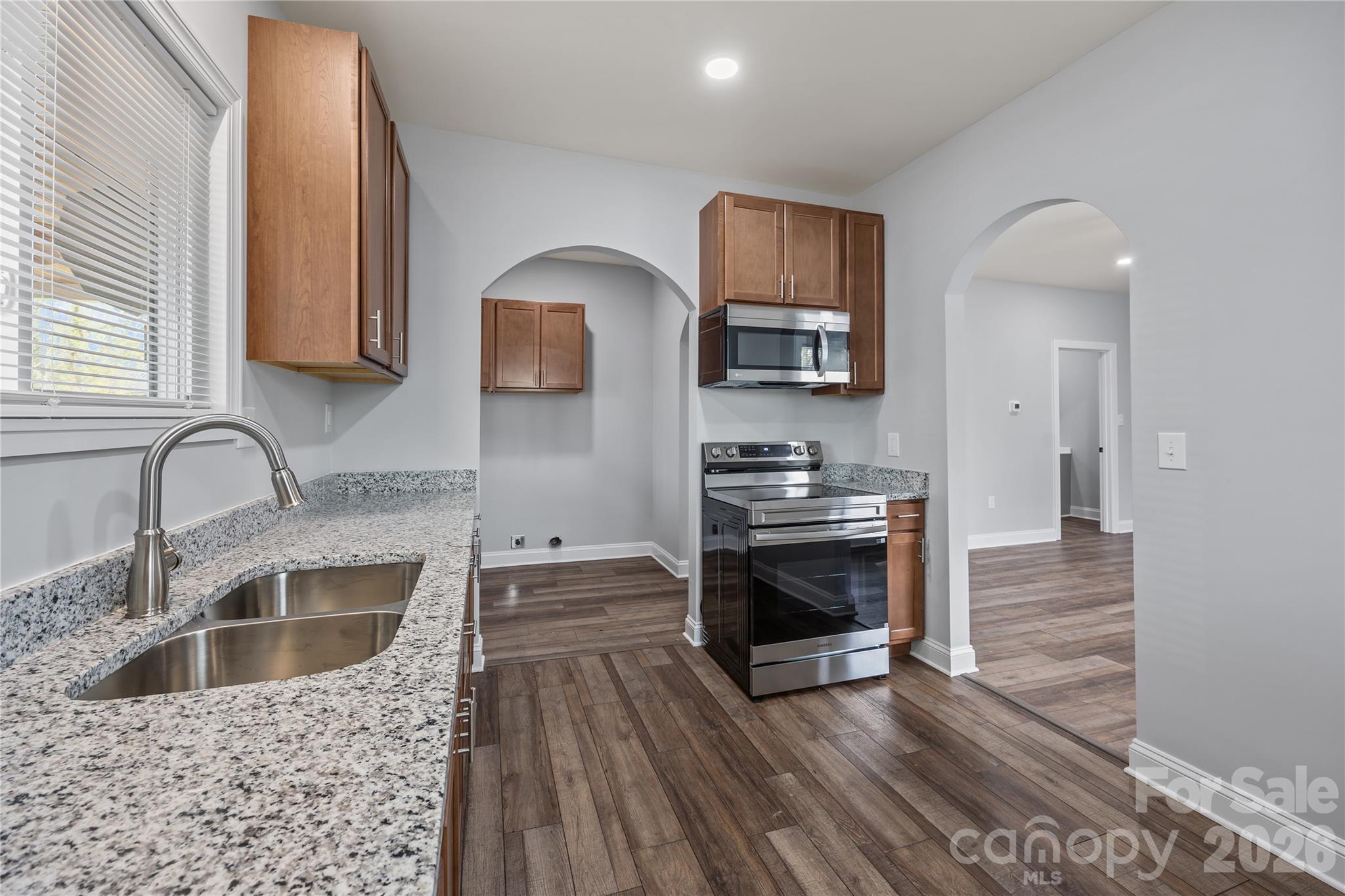 94 James Street Southwest Concord, NC 28025 - Photo 12 of 40 a kitchen with stainless steel appliances a stove a sink and a microwave