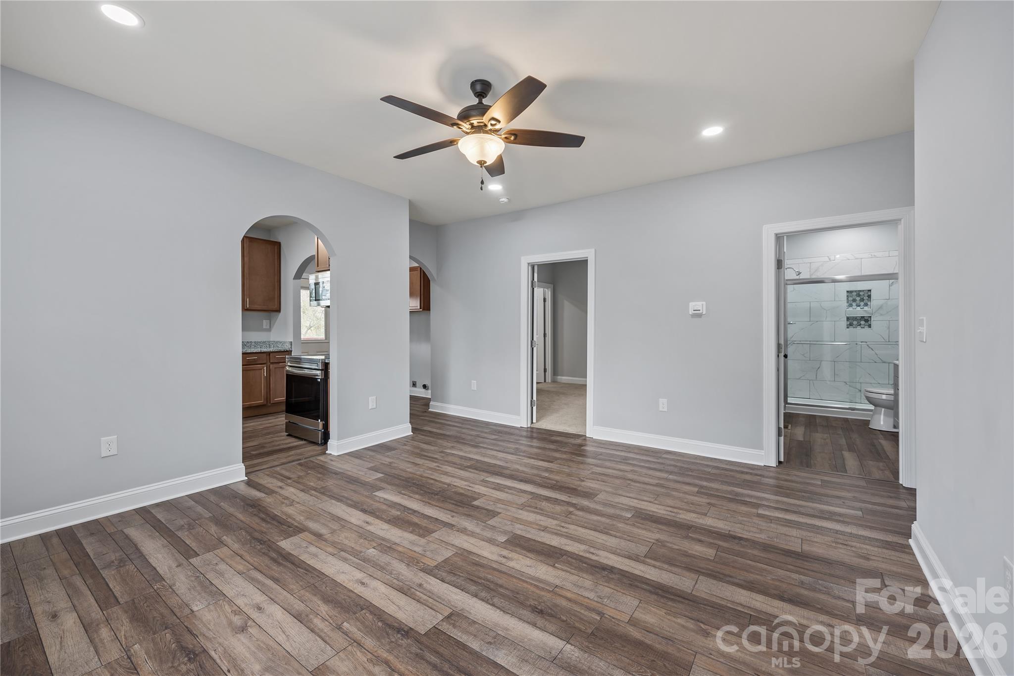 94 James Street Southwest Concord, NC 28025 - Photo 14 of 40 a view of empty room with wooden floor and ceiling fan