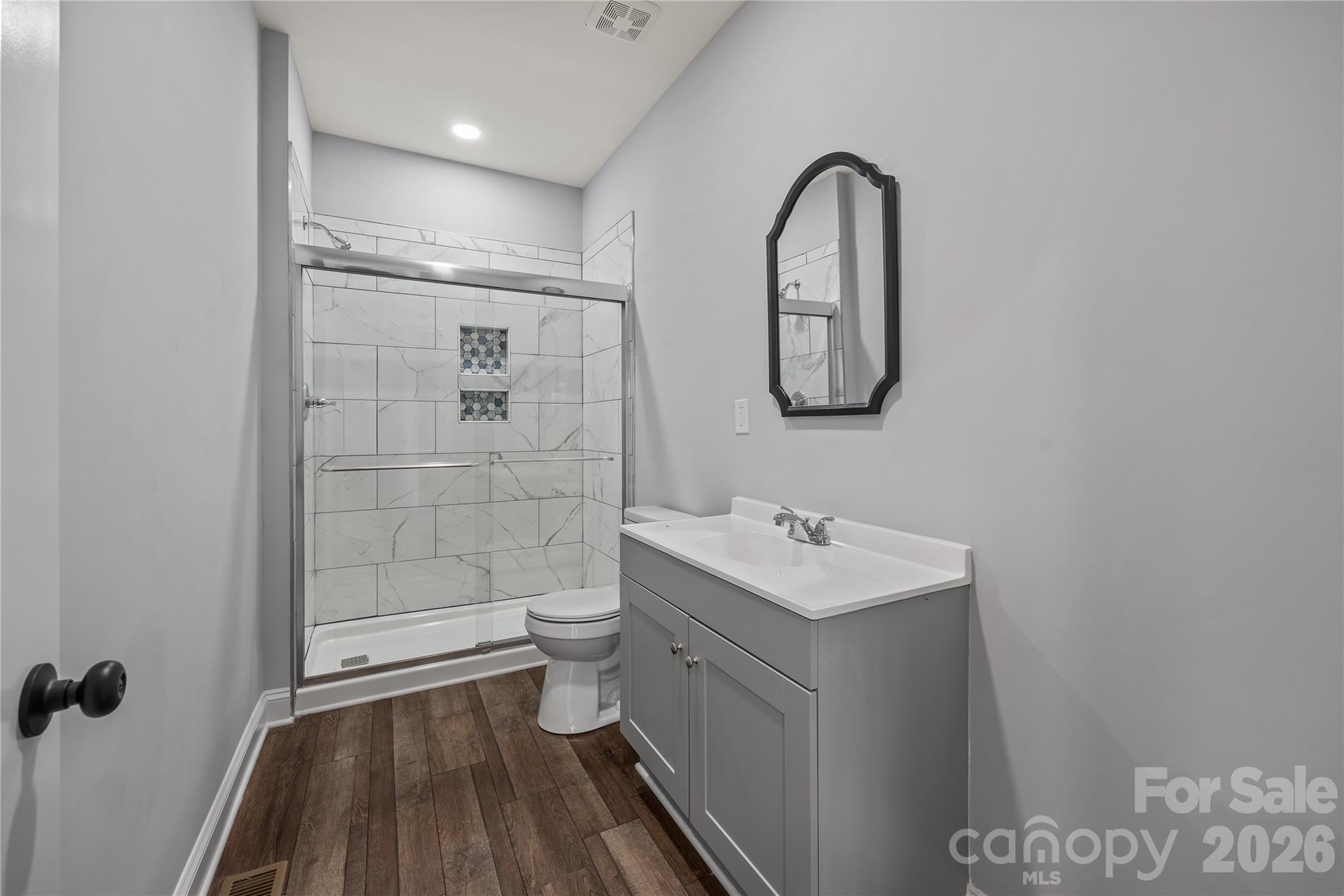 94 James Street Southwest Concord, NC 28025 - Photo 17 of 40 a bathroom with a toilet sink and shower