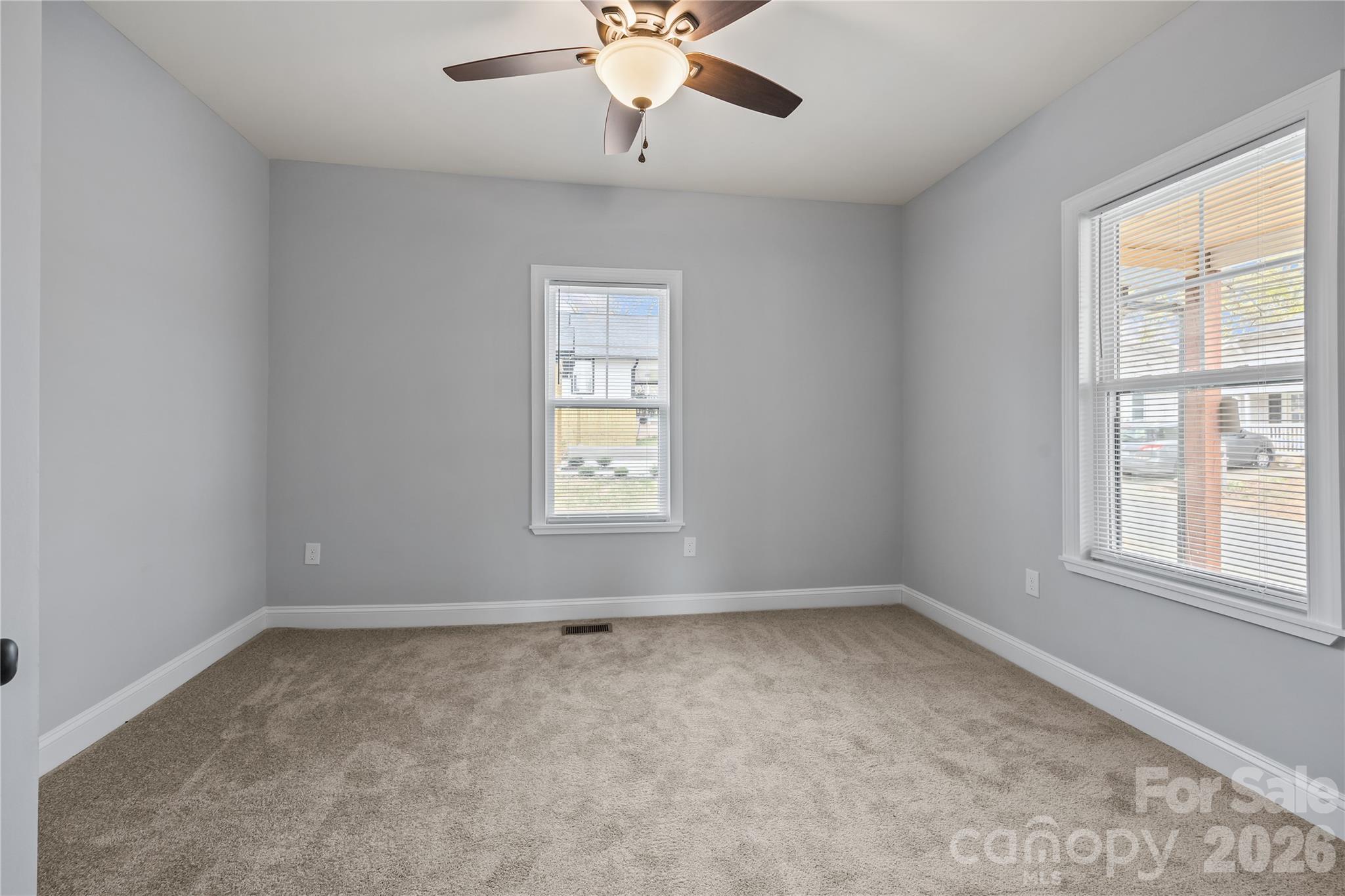 94 James Street Southwest Concord, NC 28025 - Photo 20 of 40 an empty room with a window and a fan