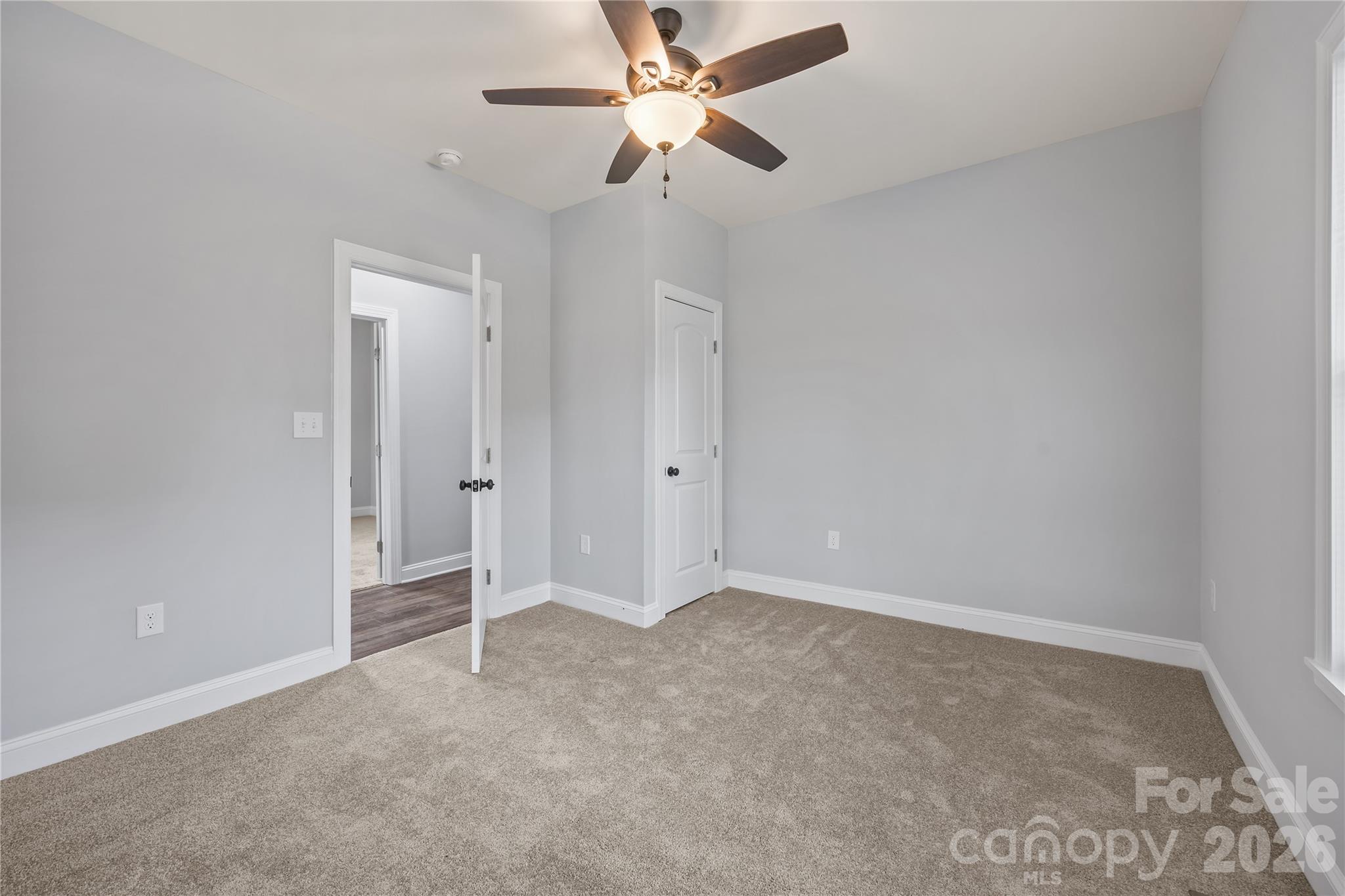 94 James Street Southwest Concord, NC 28025 - Photo 21 of 40 an empty room with closet and a ceiling fan