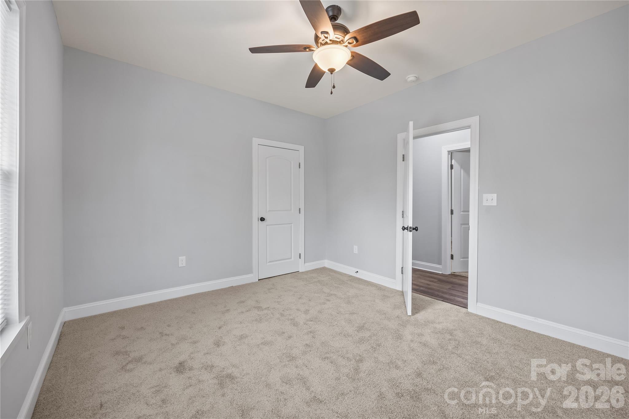 94 James Street Southwest Concord, NC 28025 - Photo 24 of 40 an empty room with closet and a ceiling fan