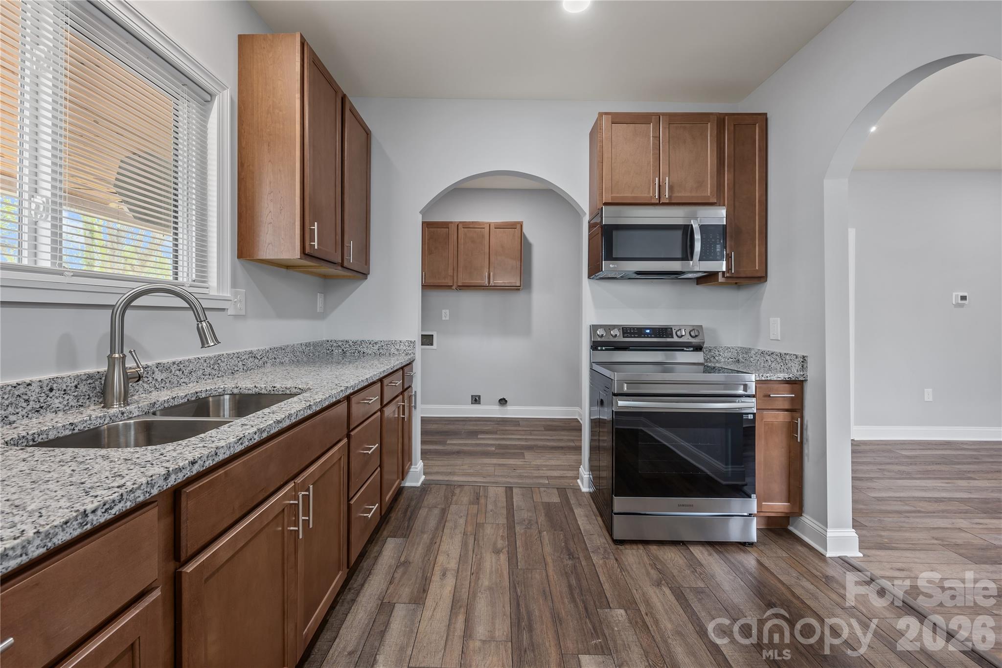 94 James Street Southwest Concord, NC 28025 - Photo 8 of 40 a kitchen with stainless steel appliances granite countertop a stove a sink and a microwave