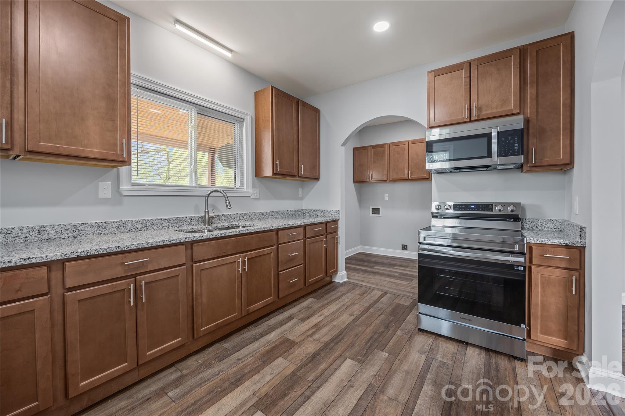 94 James Street Southwest Concord, NC 28025 - Photo 10 of 40 a kitchen with stainless steel appliances granite countertop a stove a sink and a microwave