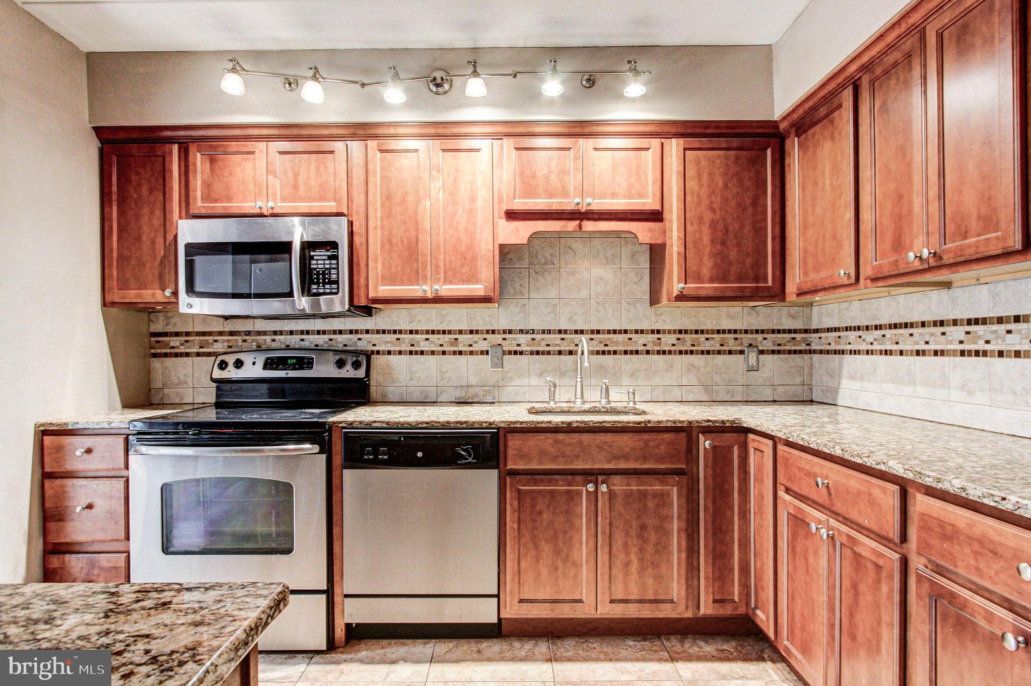 Granite counter and tile backsplash