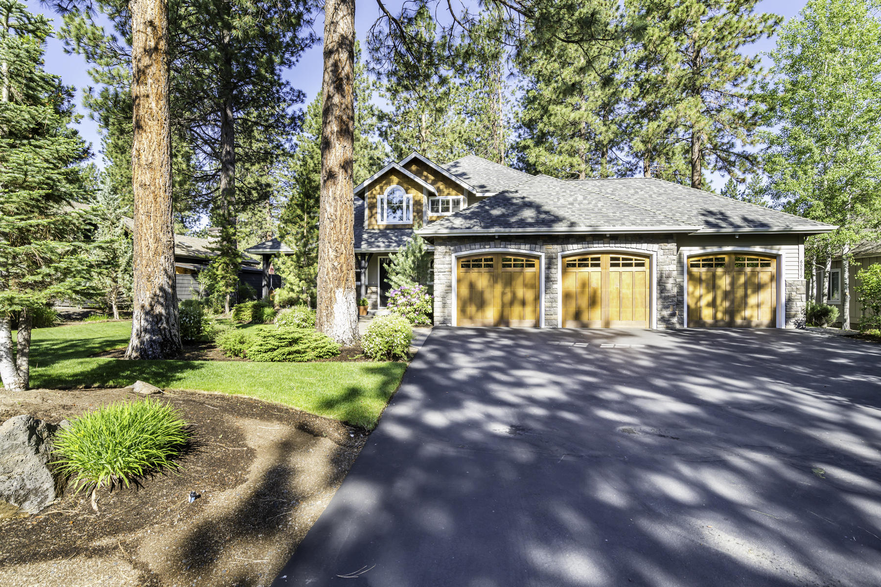 Privacy, lush landscaping, and a flat driveway welcome you to this beautiful, custom home with 3-car garage.
