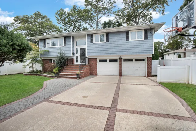 a white house that has tree in front of it