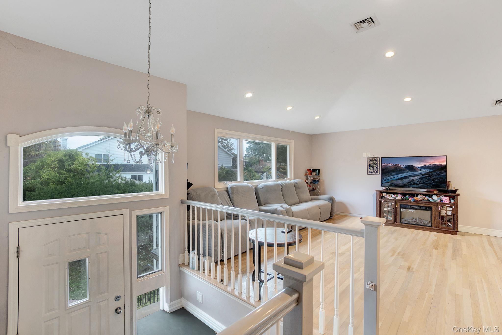 978 Little Whaleneck Road North Merrick, NY 11566 - Photo 17 of 32 Entrance foyer featuring a chandelier, recessed lighting, and wood finished floors