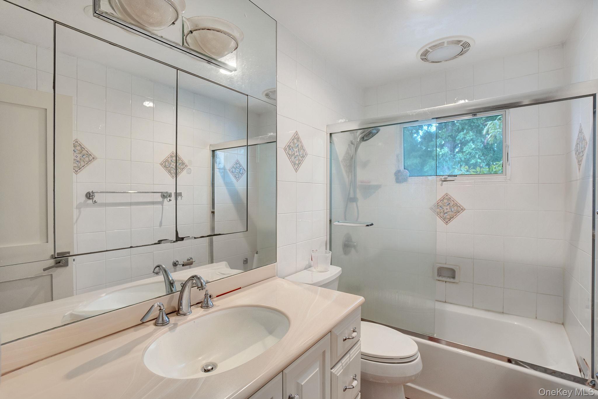 978 Little Whaleneck Road North Merrick, NY 11566 - Photo 19 of 32 Full bathroom featuring vanity and shower / bath combination with glass door
