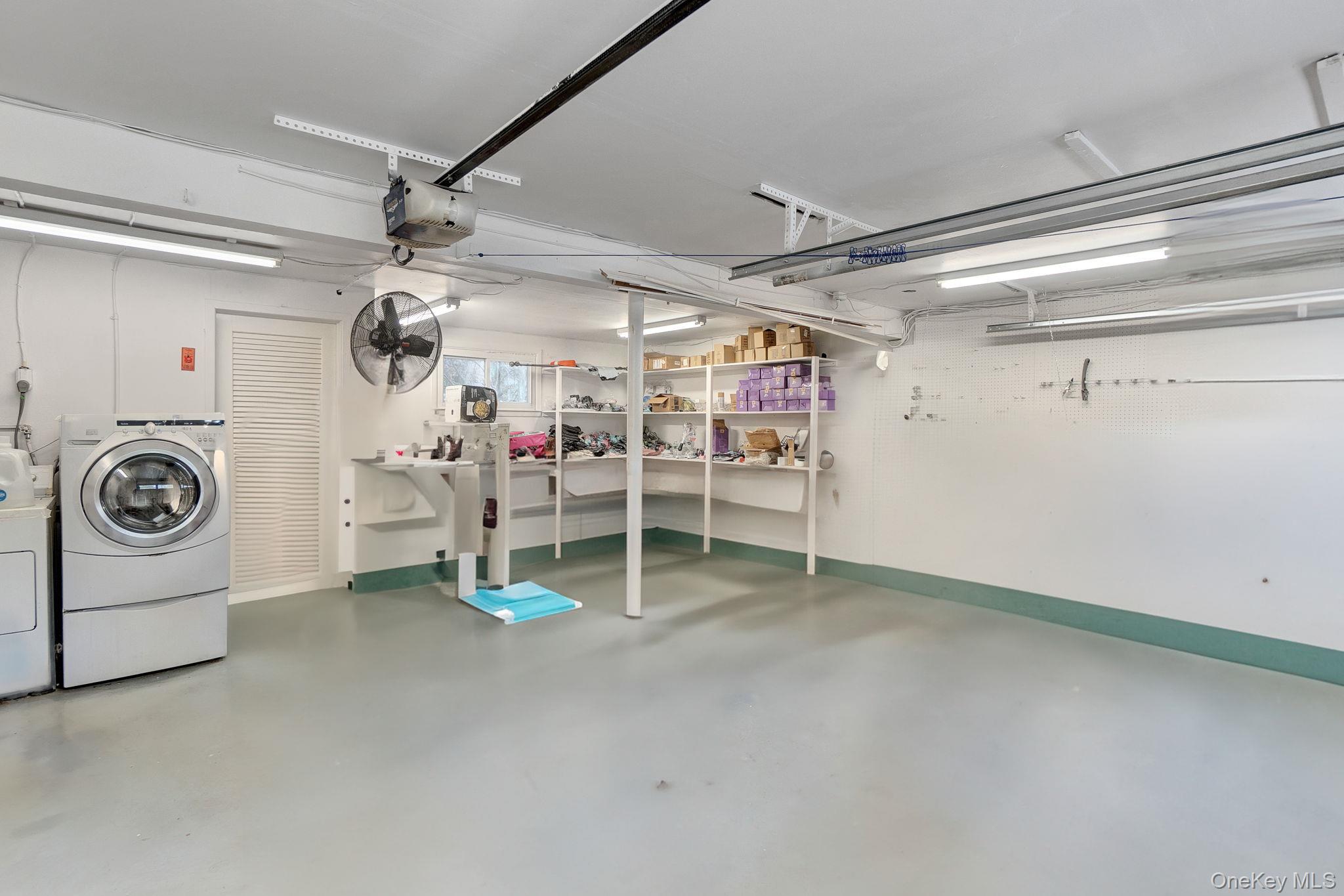 978 Little Whaleneck Road North Merrick, NY 11566 - Photo 23 of 32 Garage featuring washer and dryer and a garage door opener
