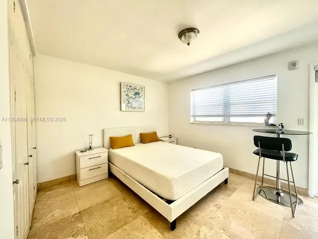 a bedroom with a bed and a chair