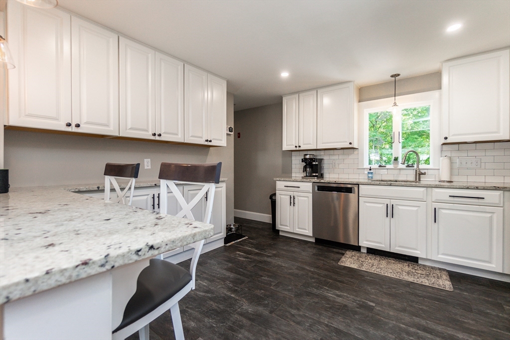 23 Thistledale Road Wakefield, MA 01880 - Photo 11 of 41 a kitchen with granite countertop a sink window and cabinets