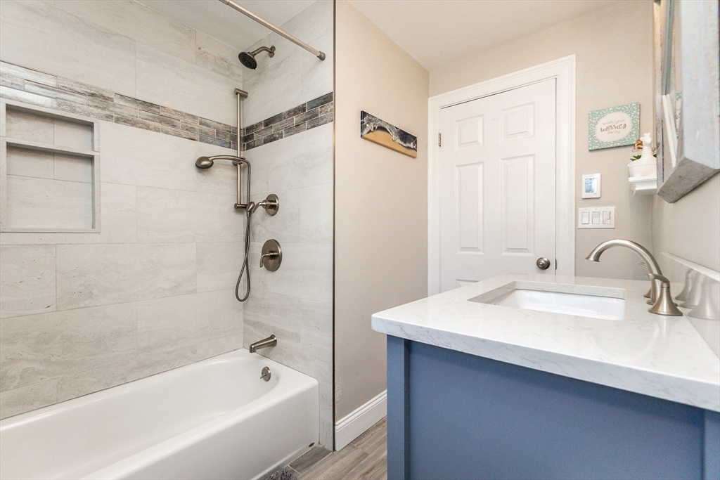 23 Thistledale Road Wakefield, MA 01880 - Photo 20 of 41 a bathroom with a tub shower sink and mirror