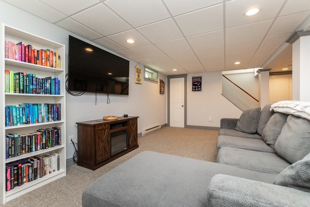 23 Thistledale Road Wakefield, MA 01880 - Photo 21 of 41 a living room with furniture and a flat screen tv