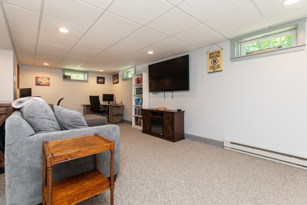23 Thistledale Road Wakefield, MA 01880 - Photo 24 of 41 a living room with furniture and a flat screen tv