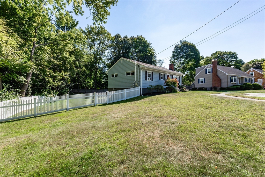23 Thistledale Road Wakefield, MA 01880 - Photo 40 of 41 a white house that has a tree in front of it