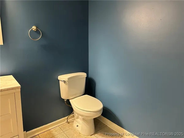 a white toilet sitting next to a shower