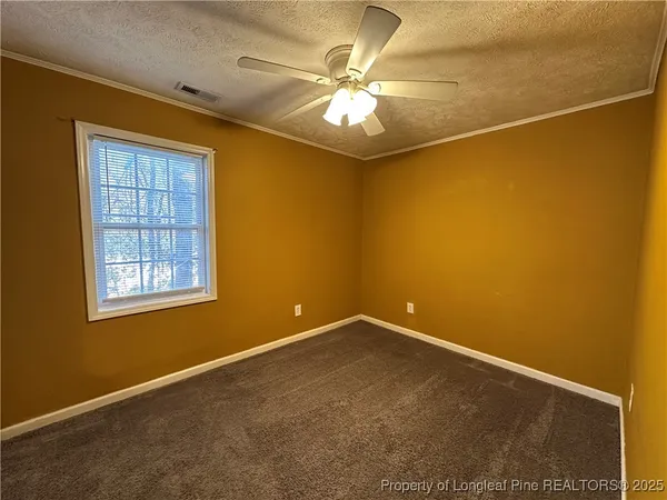 a view of room with window and ceiling fan
