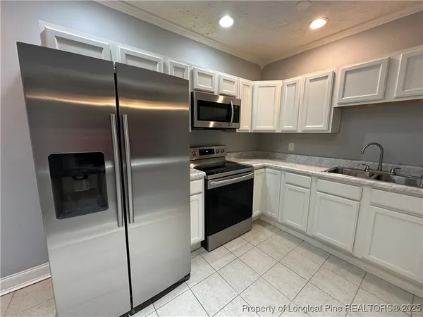 a kitchen with a refrigerator sink and microwave